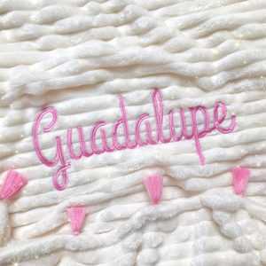 Cobija beige con flecos rosados